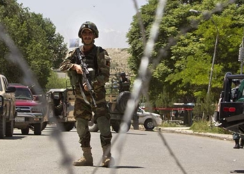 KABUL, AFGHANISTAN - MAY 21:  An Afghan security guard stands watch after a suicide bomber killed at least six people and wounded 23 more at a military hospital May 21, 2011 in Kabul, Afghanistan. The bomb went off in the cafeteria during lunchtime killing and injuring medical students and employees. The Taliban, who claimed responsibility, said they sent in two bombers to the ANA military hospital, which is in a heavily guarded area of the city. Kabul has remained relatively peaceful since early April when a suicide bomber attacked an Afghan army bus on the outskirts of the capital, wounding 10 soldiers and civilians.  (Photo by Paula Bronstein/Getty Images)