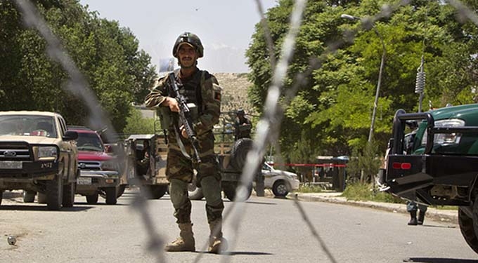 KABUL, AFGHANISTAN - MAY 21:  An Afghan security guard stands watch after a suicide bomber killed at least six people and wounded 23 more at a military hospital May 21, 2011 in Kabul, Afghanistan. The bomb went off in the cafeteria during lunchtime killing and injuring medical students and employees. The Taliban, who claimed responsibility, said they sent in two bombers to the ANA military hospital, which is in a heavily guarded area of the city. Kabul has remained relatively peaceful since early April when a suicide bomber attacked an Afghan army bus on the outskirts of the capital, wounding 10 soldiers and civilians.  (Photo by Paula Bronstein/Getty Images)