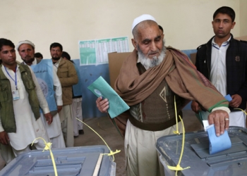 An Afghan man casts his vote at a polling station in Jalalabad, east of Kabul, Afghanistan, Saturday, April 5, 2014. Afghan voters lined up for blocks at polling stations nationwide on Saturday, defying a threat of violence by the Taliban to cast ballots in what promises to be the nation's first democratic transfer of power. (AP Photo/Rahmat Gul)