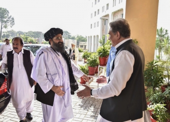 In this handout photograph taken and released by the Pakistan Foreign Ministry on October 3, 2019, Pakistan's Foreign Minister Shah Mehmood Qureshi (R) greets Taliban co-founder Mullah Baradar (2L) upon his arrival with delegation at the Pakistan Foreign Ministry in Islamabad. - Taliban co-founder Mullah Baradar arrived in Pakistan as US envoy Zalmay Khalilzad also visited, officials said, though it was unclear if they would meet for the first time since Donald Trump scuttled talks between Washington and the Islamist extremists. (Photo by HANDOUT / Pakistan Foreign Ministry / AFP) / -----EDITORS NOTE --- RESTRICTED TO EDITORIAL USE - MANDATORY CREDIT "AFP PHOTO / Pakistan Foreign Ministry " - NO MARKETING - NO ADVERTISING CAMPAIGNS - DISTRIBUTED AS A SERVICE TO CLIENTS  -