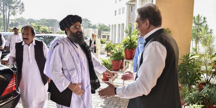 In this handout photograph taken and released by the Pakistan Foreign Ministry on October 3, 2019, Pakistan's Foreign Minister Shah Mehmood Qureshi (R) greets Taliban co-founder Mullah Baradar (2L) upon his arrival with delegation at the Pakistan Foreign Ministry in Islamabad. - Taliban co-founder Mullah Baradar arrived in Pakistan as US envoy Zalmay Khalilzad also visited, officials said, though it was unclear if they would meet for the first time since Donald Trump scuttled talks between Washington and the Islamist extremists. (Photo by HANDOUT / Pakistan Foreign Ministry / AFP) / -----EDITORS NOTE --- RESTRICTED TO EDITORIAL USE - MANDATORY CREDIT "AFP PHOTO / Pakistan Foreign Ministry " - NO MARKETING - NO ADVERTISING CAMPAIGNS - DISTRIBUTED AS A SERVICE TO CLIENTS  -