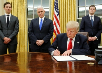 January 20, 2017 - Washington, District of Columbia, U.S. - U.S. President Donald Trump, flanked by Senior Advisor Jared Kushner (standing, L-R), Vice President Mike Pence and Staff Secretary Rob Porter welcomes reporters into the Oval Office for him to sign his first executive orders at the White House. (Credit Image: © Jonathan Ernst/Reuters via ZUMA Press)