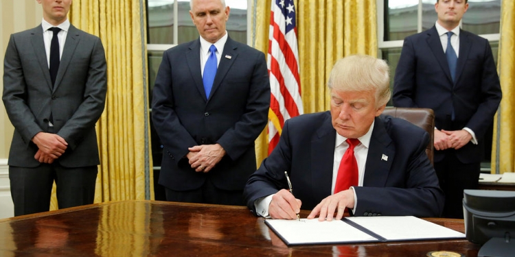 January 20, 2017 - Washington, District of Columbia, U.S. - U.S. President Donald Trump, flanked by Senior Advisor Jared Kushner (standing, L-R), Vice President Mike Pence and Staff Secretary Rob Porter welcomes reporters into the Oval Office for him to sign his first executive orders at the White House. (Credit Image: © Jonathan Ernst/Reuters via ZUMA Press)