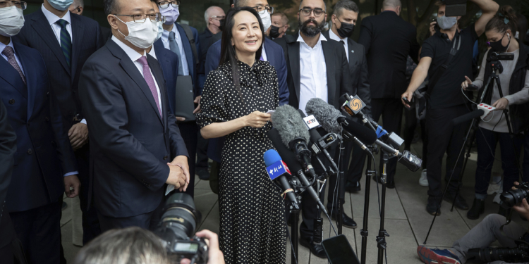 Meng Wanzhou, chief financial officer of Huawei, reads a statement outside B.C. Supreme Court, in Vancouver, B.C., Friday, Sept. 24, 2021. THE CANADIAN PRESS/Darryl Dyck