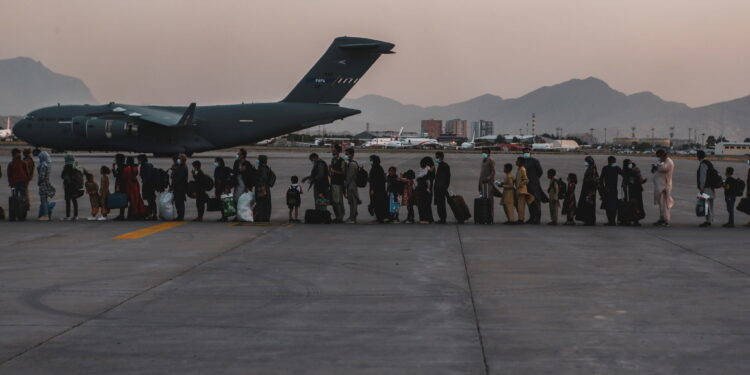 FILE PHOTO: Evacuees wait to board a Boeing C-17 Globemaster III during an evacuation at Hamid Karzai International Airport in Kabul, Afghanistan, August 23, 2021. Picture taken August 23, 2021. U.S. Marine Corps/Sgt. Isaiah Campbell/Handout via REUTERS