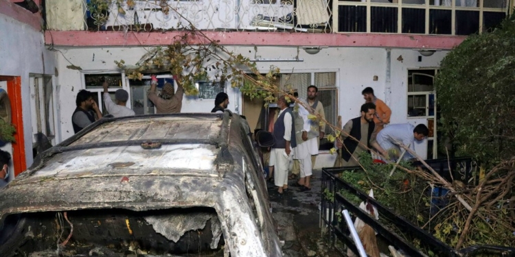 FILE - In this Sunday, Aug. 29, 2021 file photo, Afghans inspect damage of Ahmadi family house after U.S. drone strike in Kabul, Afghanistan, Sunday, Aug. 29, 2021. Ahmadi says Sunday's U.S. drone strike killed 10 members of his family, six of them children. Senior U.S. military officials said the drone strike hit an Islamic State target and disrupted the extremist' ability to further disrupt the final phase of the U.S. withdrawal from Afghanistan. (AP Photo/Khwaja Tawfiq Sediqi, File)