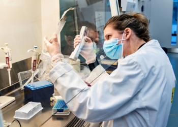 A person uses laboratory equipment as researchers at Aalborg University screen and analyse all the positive Danish coronavirus disease (COVID-19) samples for the new English virus variant "cluster B.1.1.7", in Aalborg, Denmark January 15, 2021.  Ritzau Scanpix/Henning Bagger via REUTERS    ATTENTION EDITORS - THIS IMAGE WAS PROVIDED BY A THIRD PARTY. DENMARK OUT. NO COMMERCIAL OR EDITORIAL SALES IN DENMARK.