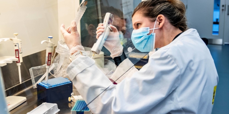 A person uses laboratory equipment as researchers at Aalborg University screen and analyse all the positive Danish coronavirus disease (COVID-19) samples for the new English virus variant "cluster B.1.1.7", in Aalborg, Denmark January 15, 2021.  Ritzau Scanpix/Henning Bagger via REUTERS    ATTENTION EDITORS - THIS IMAGE WAS PROVIDED BY A THIRD PARTY. DENMARK OUT. NO COMMERCIAL OR EDITORIAL SALES IN DENMARK.
