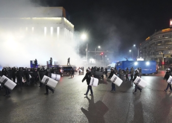 Riot police walk to block protesters in the center of Almaty, Kazakhstan, Wednesday, Jan. 5, 2022. Demonstrators denouncing the doubling of prices for liquefied gas have clashed with police in Kazakhstan's largest city and held protests in about a dozen other cities in the country. Local news reports said police dispersed a demonstration of about a thousand people Tuesday night in Almaty and that some demonstrators were detained. (AP Photo/Vladimir Tretyakov)