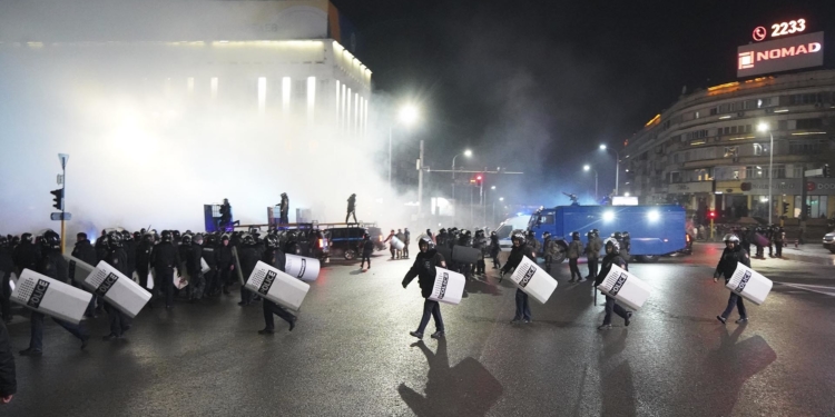 Riot police walk to block protesters in the center of Almaty, Kazakhstan, Wednesday, Jan. 5, 2022. Demonstrators denouncing the doubling of prices for liquefied gas have clashed with police in Kazakhstan's largest city and held protests in about a dozen other cities in the country. Local news reports said police dispersed a demonstration of about a thousand people Tuesday night in Almaty and that some demonstrators were detained. (AP Photo/Vladimir Tretyakov)