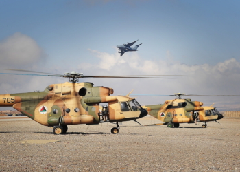 A Royal Australian Air Force C-17A Globemaster aircraft flies over Mi-17 helicopters belonging to the Afghan Air Force's 2nd Wing at Multinational Base Tarin Kowt in Uruzgan province, Afghanistan, Feb. 23, 2013.  (U.S. Army courtesy photo/Released)