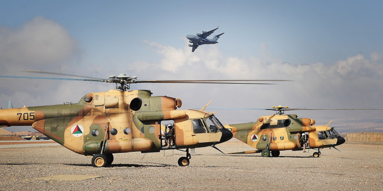 A Royal Australian Air Force C-17A Globemaster aircraft flies over Mi-17 helicopters belonging to the Afghan Air Force's 2nd Wing at Multinational Base Tarin Kowt in Uruzgan province, Afghanistan, Feb. 23, 2013. (U.S. Army courtesy photo/Released)