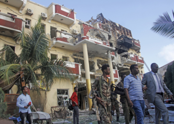 Security forces and others walk in front of the damaged Hayat Hotel in the capital Mogadishu, Somalia Sunday, Aug. 21, 2022. Somali authorities on Sunday ended a deadly attack in which at least 20 people were killed and many others wounded when gunmen from the Islamic extremist group al-Shabab, which has ties with al-Qaida, stormed the Hayat Hotel in the capital on Friday evening. (AP Photo/Farah Abdi Warsameh)