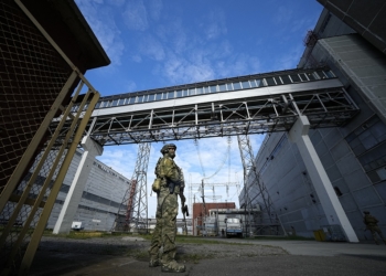 FILE - A Russian serviceman guards an area of the Zaporizhzhia Nuclear Power Station in territory under Russian military control, southeastern Ukraine, May 1, 2022. Russia and Ukraine have trade blame over shelling of the Zaporizhzhia nuclear power plant, Europe's largest. This photo was taken during a trip organized by the Russian Ministry of Defense. (AP Photo, File)