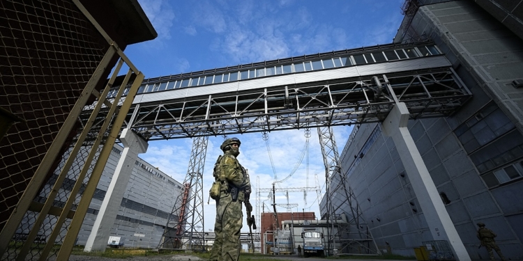FILE - A Russian serviceman guards an area of the Zaporizhzhia Nuclear Power Station in territory under Russian military control, southeastern Ukraine, May 1, 2022. Russia and Ukraine have trade blame over shelling of the Zaporizhzhia nuclear power plant, Europe's largest. This photo was taken during a trip organized by the Russian Ministry of Defense. (AP Photo, File)
