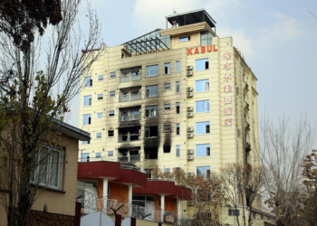 A hotel building sits charred after an attack in Kabul, Afghanistan, Tuesday, Dec. 13, 2022. The militant Islamic State group has claimed responsibility for a coordinated attack on the Chinese-owned hotel in Afghanistan's capital that left three assailants dead and at least two of the hotel guests injured as they tried to escape by jumping out from a window. (AP Photo/Siddiqullah Khan)