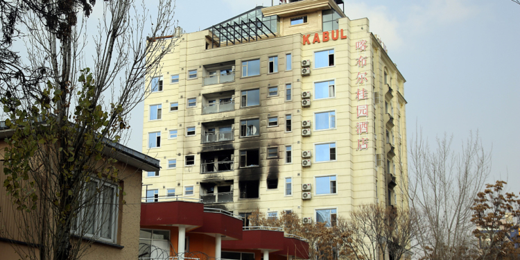 A hotel building sits charred after an attack in Kabul, Afghanistan, Tuesday, Dec. 13, 2022. The militant Islamic State group has claimed responsibility for a coordinated attack on the Chinese-owned hotel in Afghanistan's capital that left three assailants dead and at least two of the hotel guests injured as they tried to escape by jumping out from a window. (AP Photo/Siddiqullah Khan)