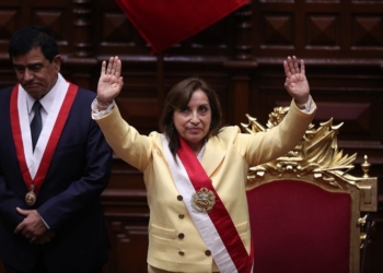 Former Vice President Dina Boluarte acknowledges lawmakers after she was sworn in as president in Lima, Peru, Wednesday, Dec. 7, 2022. Behind is Congress President Jose Williams. Peru's Congress voted to remove President Pedro Castillo from office Wednesday and replace him with the vice president, shortly after Castillo tried to dissolve the legislature ahead of a scheduled vote to remove him. (AP Photo/Guadalupe Pardo)