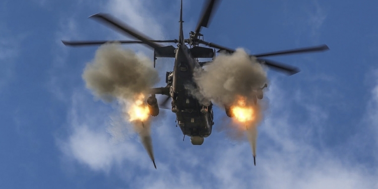 FILE - In this handout photo taken from video and released by Russian Defense Ministry Press Service on Oct. 28, 2022, a Russian Ka-52 helicopter gunship fires at a target in an unknown location in Ukraine. As Russia’s invasion of Ukraine enters its second year, both sides hope to turn the tide of war with big offensives. (Russian Defense Ministry Press Service via AP, File)