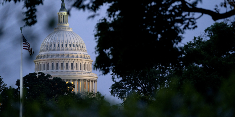 The U.S. Capitol building and American flag. Photographer: Stefani Reynolds/Bloomberg