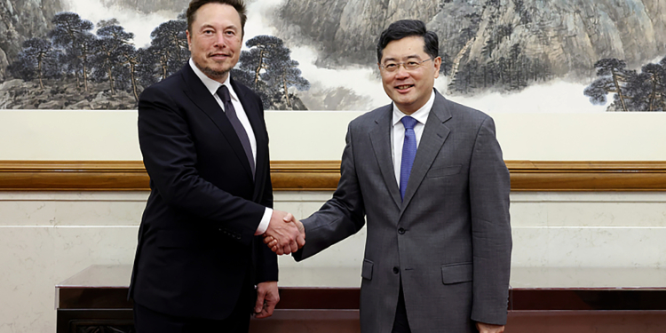 In this photo taken Tuesday, May 30 2023 and released by Ministry of Foreign Affairs of the People's Republic of China, China's Foreign Minister Qin Gang, right, poses for photos with Tesla Ltd. CEO Elon Musk in Beijing. China’s foreign minister met Tesla Ltd. CEO Elon Musk on Tuesday and said strained U.S.-Chinese relations require “mutual respect,” while delivering a message of reassurance that foreign companies are welcome. (Ministry of Foreign Affairs of the People's Republic of China via AP)