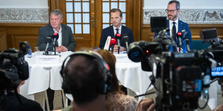 From left, Minister of Foreign Affairs Lars Loekke Rasmussen, Minister of Justice Peter Hummelgaard and Deputy Prime Minister Jakob Ellemann-Jensen present a bill on a Quran burning ban on a doorstep in Christiansborg, Copenhagen, Friday, Aug. 25, 2023. (Martin Sylvest/Ritzau Scanpix via AP)