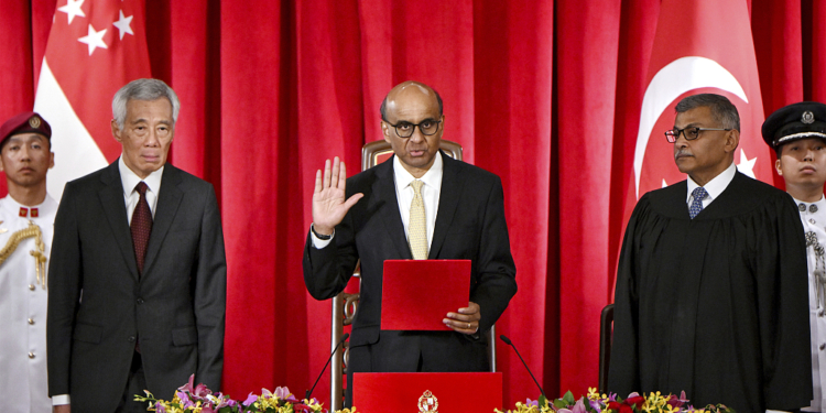 President Tharman Shanmugaratnam, flanked by Prime Minister Lee Hsien Loong (left) and Chief Justice Sundaresh Menon, taking his oath at the presidential inauguration at the Istana, 14 September 2023. President Tharman won the presidential election held on 1 September to become Singapore's ninth president. (Singapore Press via AP Images)