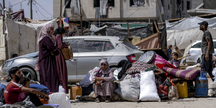 Palestinians displaced by the Israeli air and ground offensive on the Gaza Strip flee from Hamad City, following an evacuation order by the Israeli army to leave parts of the southern area of Khan Younis, Sunday, Aug. 11, 2024. (AP Photo/Abdel Kareem Hana)