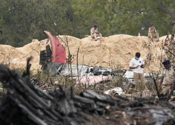 Police personnel work at the site of an Air India plane crash in Ahmedabad, India, Friday, June 13, 2025. (AP Photo/Rafiq Maqbool)