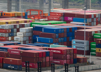 CHONGQING, CHINA - JULY 20: Intermodal shipping containers from global logistics companies including Maersk, Evergreen, ONE, Hamburg Süd, Samsung, and CMA CGM are seen stacked at the Guoyuan Operations Area of the Port of Chongqing, located along the Yangtze River and known as the largest inland intermodal terminal in China, on July 20, 2025 in Chongqing, China. (Photo by Cheng Xin/Getty Images)
