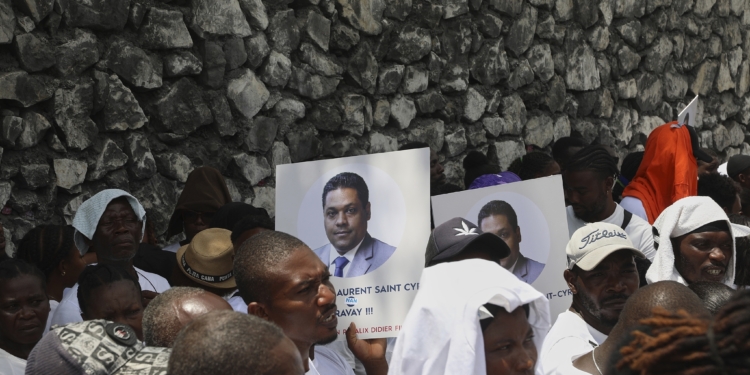 Supporters celebrate the installation of Laurent Saint-Cyr, who replaces Fritz Alphonse Jean, in the rotating presidency of the transitional presidential council in Port-au-Prince, Haiti, Thursday, Aug. 7, 2025. (AP Photo/Odelyn Joseph)