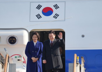 South Korean President Lee Jae Myung and his wife Kim Hea Kyung prepare to leave for China at the Seoul airport in Seongnam, South Korea, Sunday, Jan. 4, 2026. (AP Photo/Lee Jin-man)