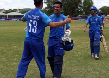 WINDHOEK, NAMIBIA - JANUARY 21: Faisal Khan of Afghanistan celebrates victory with teammate Mahboob Khan after the ICC U19 Men's Cricket World Cup 2026 match between Afghanistan and Tanzania at HP Oval on January 21, 2026 in Windhoek, Namibia. (Photo by Matthew Lewis-ICC/ICC via Getty Images)