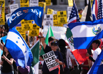 People gather during a protest on Friday, Jan. 30, 2026, in Los Angeles. (AP Photo/Jae C. Hong)