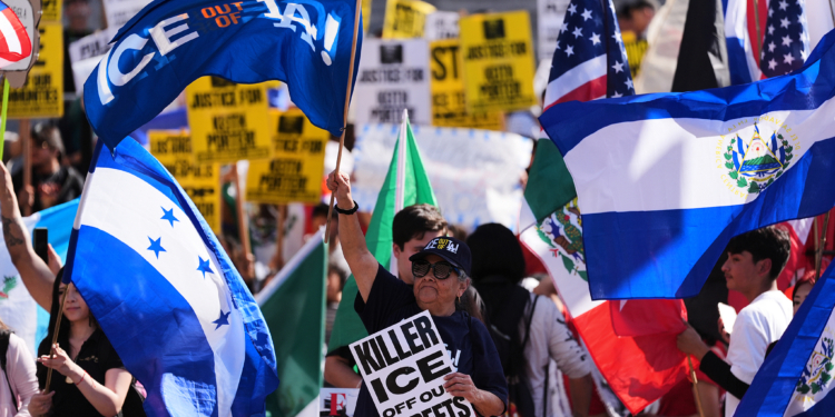 People gather during a protest on Friday, Jan. 30, 2026, in Los Angeles. (AP Photo/Jae C. Hong)