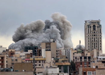 A plume of smoke rises after a strike in Tehran, Iran, Monday, March 2, 2026. (AP Photo/Mohsen Ganji) Screenshot