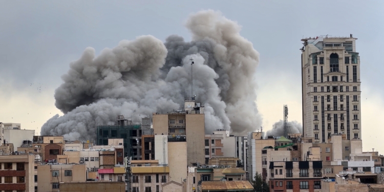 A plume of smoke rises after a strike in Tehran, Iran, Monday, March 2, 2026. (AP Photo/Mohsen Ganji) Screenshot