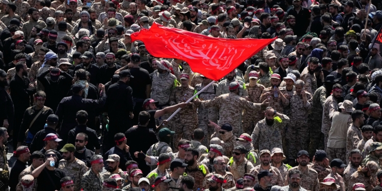 Uniformed members of the Islamic Revolutionary Guard Corps wave a Shiite religious flag during the funeral procession of the slain Iranian Supreme Leader Ayatollah Ali Khamenei and members of his family in Tehran, Iran, Monday, July 6, 2026. (AP Photo/Vahid Salemi)