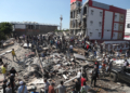 Residents and rescue workers search through the rubble of a collapsed building after an earthquake struck Cali, Colombia, Monday, Aug. 10, 2026. (AP Photo/Santiago Saldarriaga)