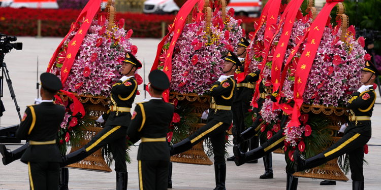 A military honor guard presents flower baskets to fallen national heroes at the Monument to the People's Heroes to mark Martyrs' Day at Tiananmen Square in Beijing, Wednesday, Sept. 30, 2026. (AP Photo/Ng Han Guan)