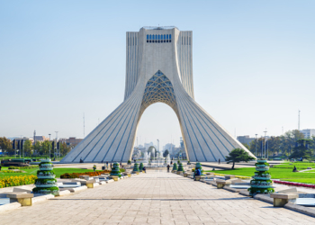 Beautiful view of the Azadi Tower (Freedom Tower) on blue sky background in Tehran, Iran. Azadi Square is a popular tourist attraction of the Middle East.