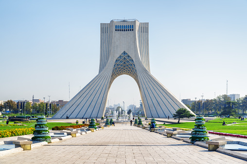Beautiful view of the Azadi Tower (Freedom Tower) on blue sky background in Tehran, Iran. Azadi Square is a popular tourist attraction of the Middle East.
